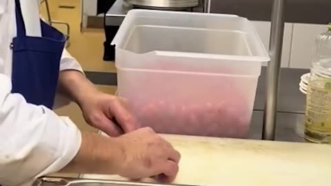 Sensei shows student how to slice Tomato