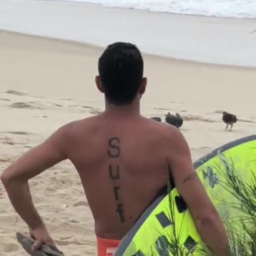 Guy highlight yellow surfboard surf tattoo on back