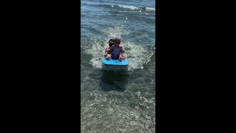 Toddler surfing first wave