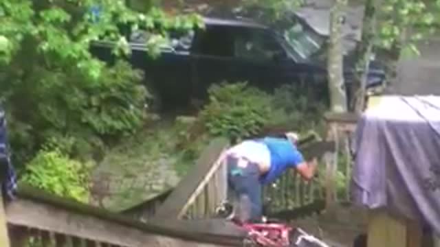 Blue shirt mountain bike down wooden steps runs into railing