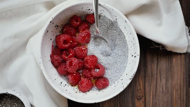 Close-Up View of Bowl of Raspberries With Chia Seeds and Milk