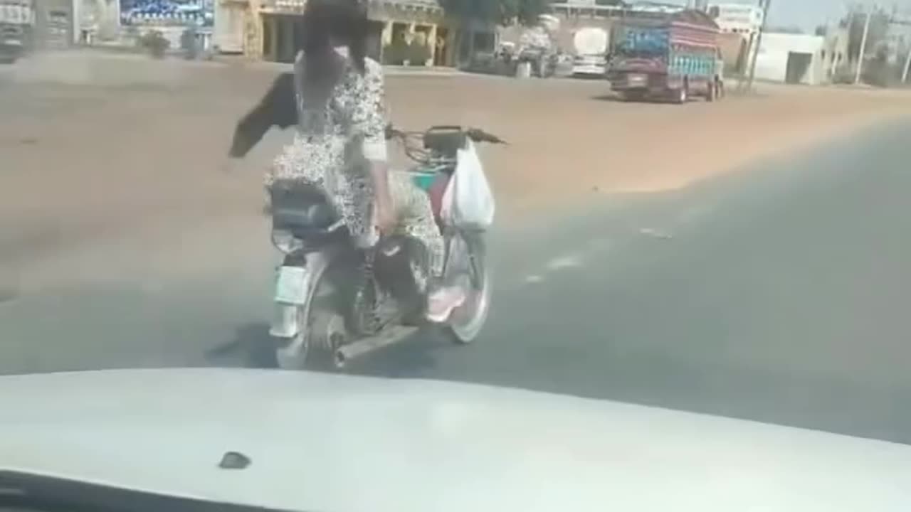 A girl riding a bike with free handed