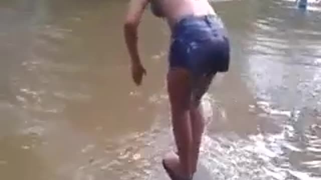 young girls jumping in the river