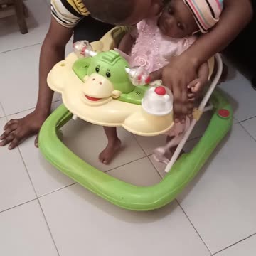 Dad and daughter having fun on a walker.