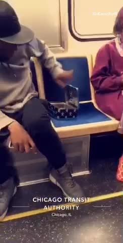 Guy petting small rat puts rat into blue tin box closes subway train