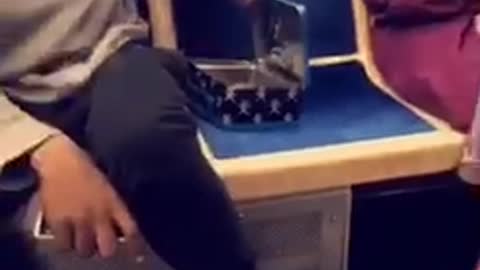 Guy petting small rat puts rat into blue tin box closes subway train