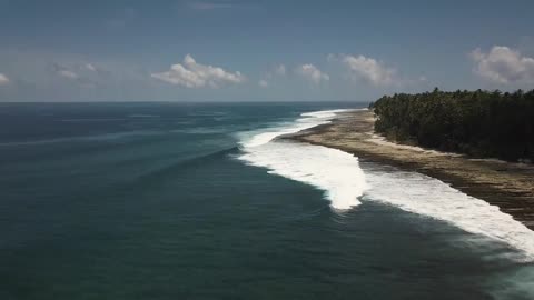 Drone footage of waves at a beach