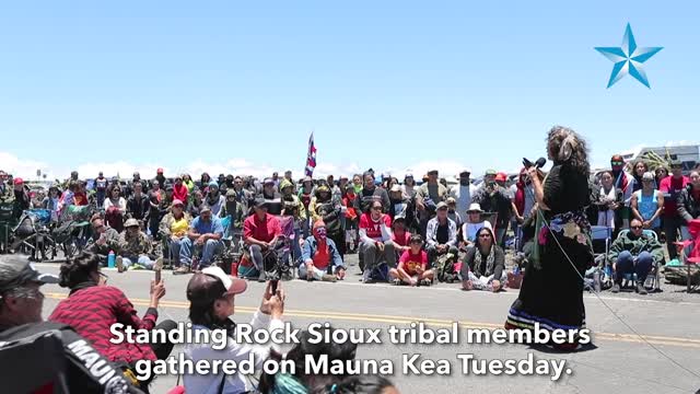 Standing Rock Sioux tribal members stand with Thirty Meter Telescope opponents on Mauna Kea