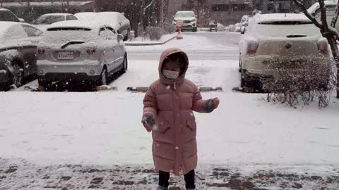 the cute baby fall in the snow.