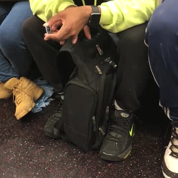 Man bright green sweater clipping nails