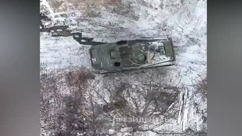 Ukrainian quadcopter drones drop grenades on Russian BMP-2 armored vehicle.