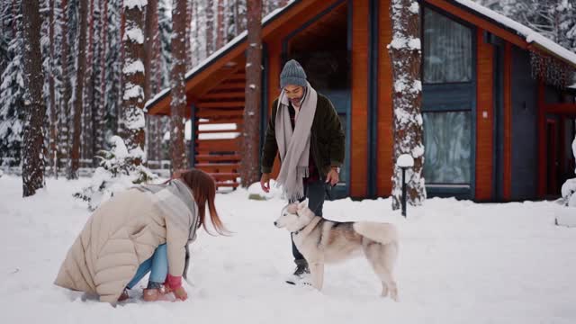 Man and women enjoying with their pet dog