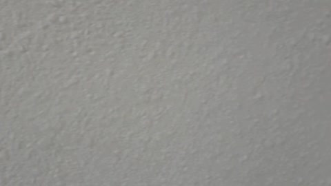 applying liquid wallpaper to the wall