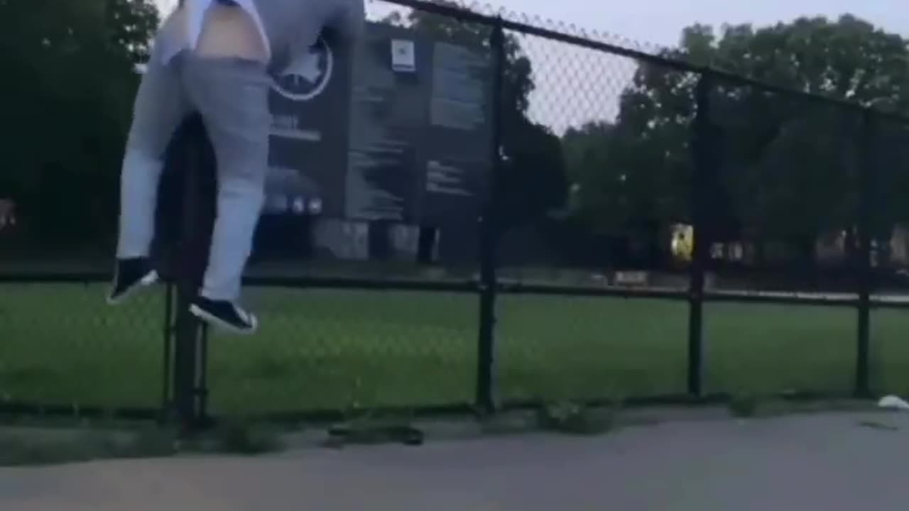 Guy's underwear gets caught trying to jump a fence