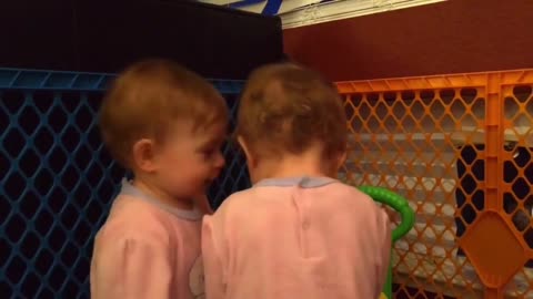 Twin babies share heart-warming moment