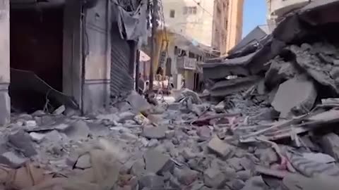 Child refuses to leave rubble of family shop in Gaza