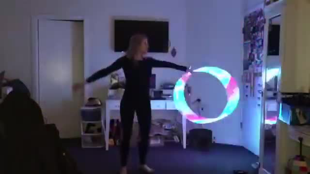 Girl Swings Around Light up Hula Hoop in Dark Room