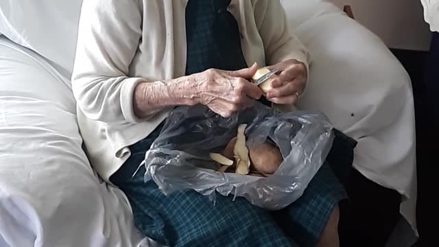 Mrs. Miller peeling taters