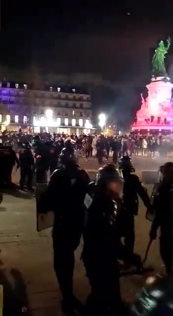 One of macron's minions throws a gas grenade straight off the head of a protester in Paris.