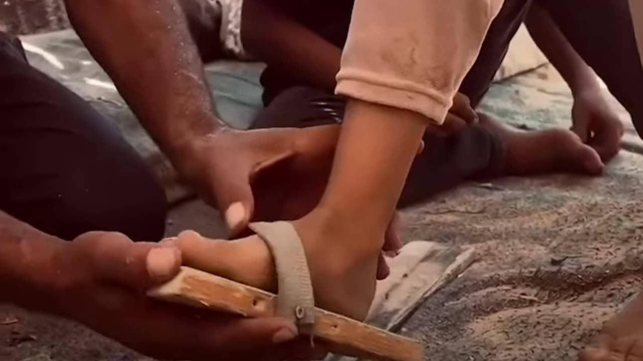 Displaced Palestinian in Gaza crafts slippers from wood and fabric