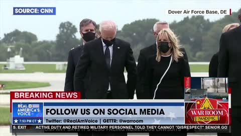 Joe Biden looking at watch during the dignified transfer at Dover AFB