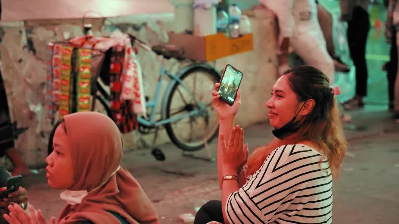 Tracking Shot of Women Clapping in Jakarta