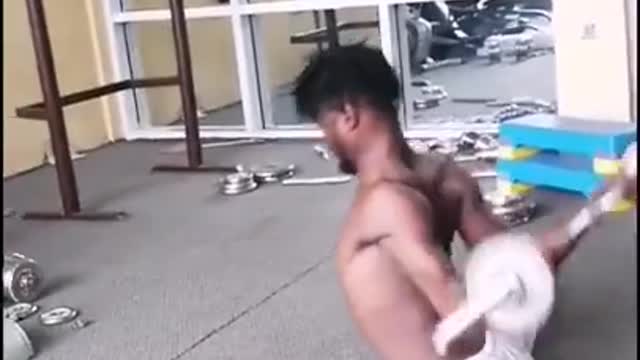 Guy Splits And Lifts Weights After Twisting His Hands Backward