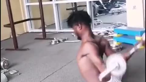 Guy Splits And Lifts Weights After Twisting His Hands Backward