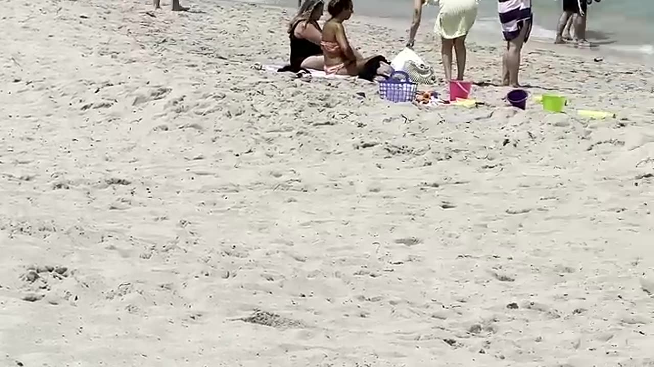 Grils chill on the beach