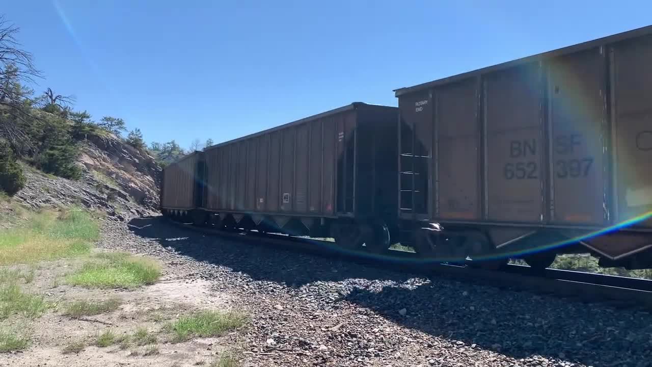 Solid EMD SD70ACe lineup up Mullan Pass. 3 BNSF, 4 MRL, then 1 BNSF on the rear.