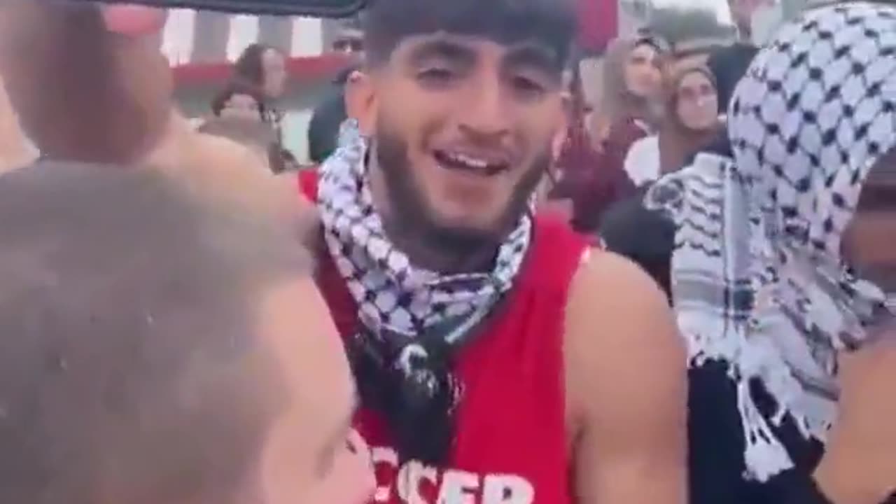 Palestine supporter taunts an Israel supporter with a video of hostages captured by Hamas