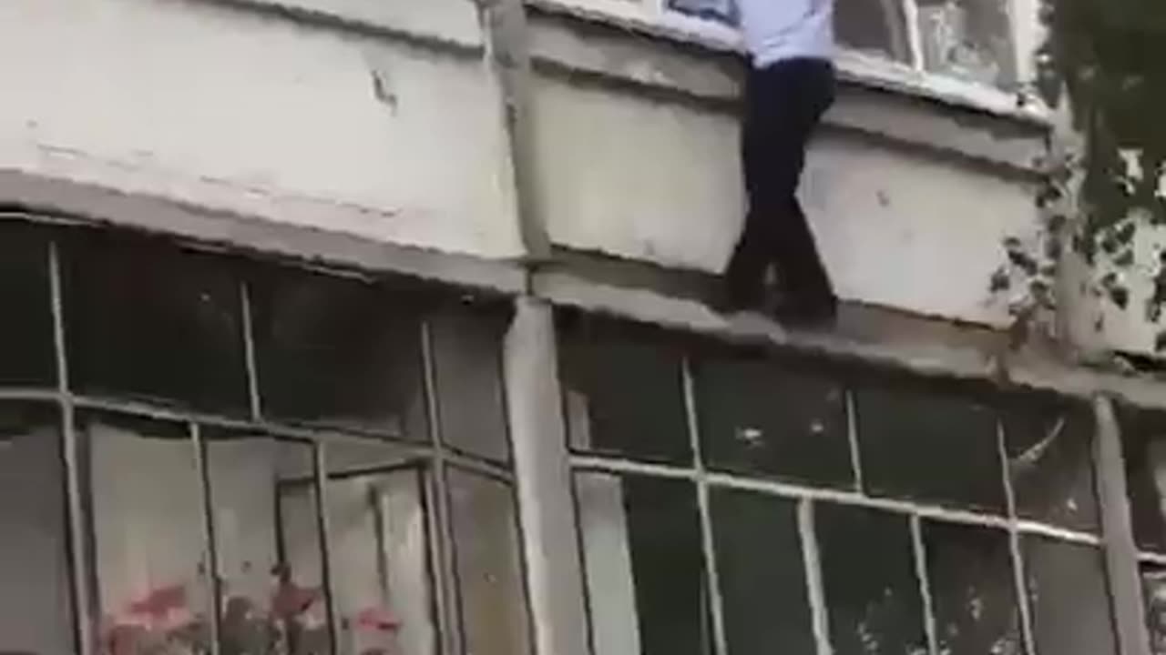 A policeman miraculously saved a child who was trying to be thrown out of a window