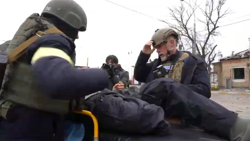 Reporter in Ukraine Carries Elderly Man Evacuating a Hospital