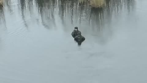 Russians Standing Chest Deep in River from Reasons Unknown