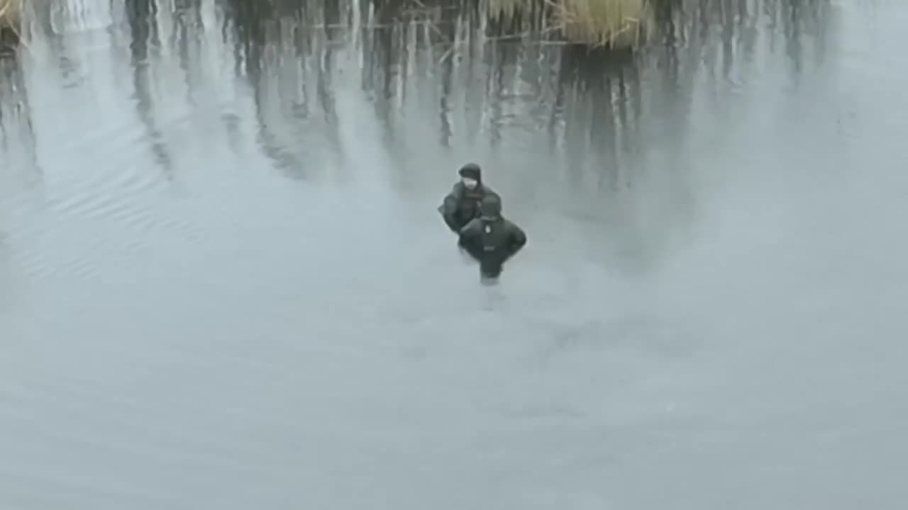 Russians Standing Chest Deep in River from Reasons Unknown