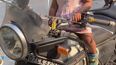 Baby girl trying to start a Motorcycle