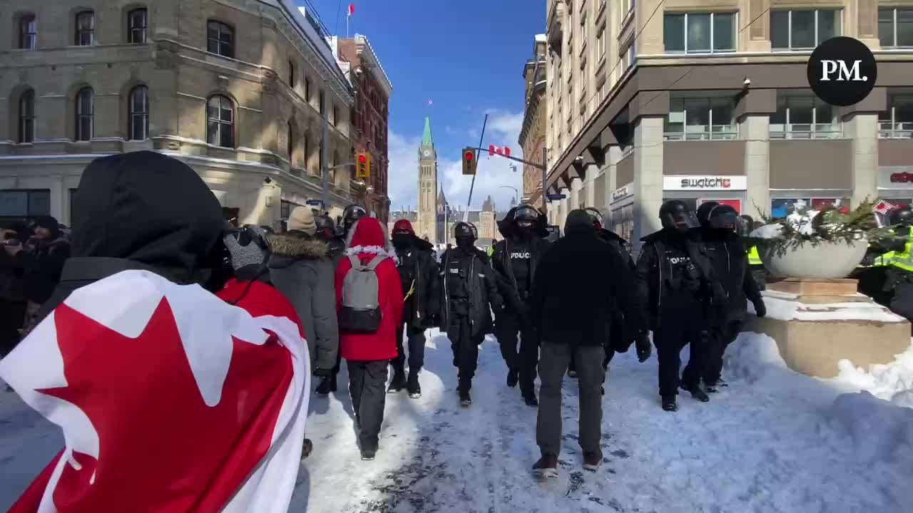 Freedom protestors sing O Canada as police drive them away from Parliament Hill