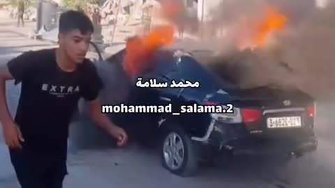 Two civilian vehicles burning at the Bani Suhaila roundabout near Khan Yunis