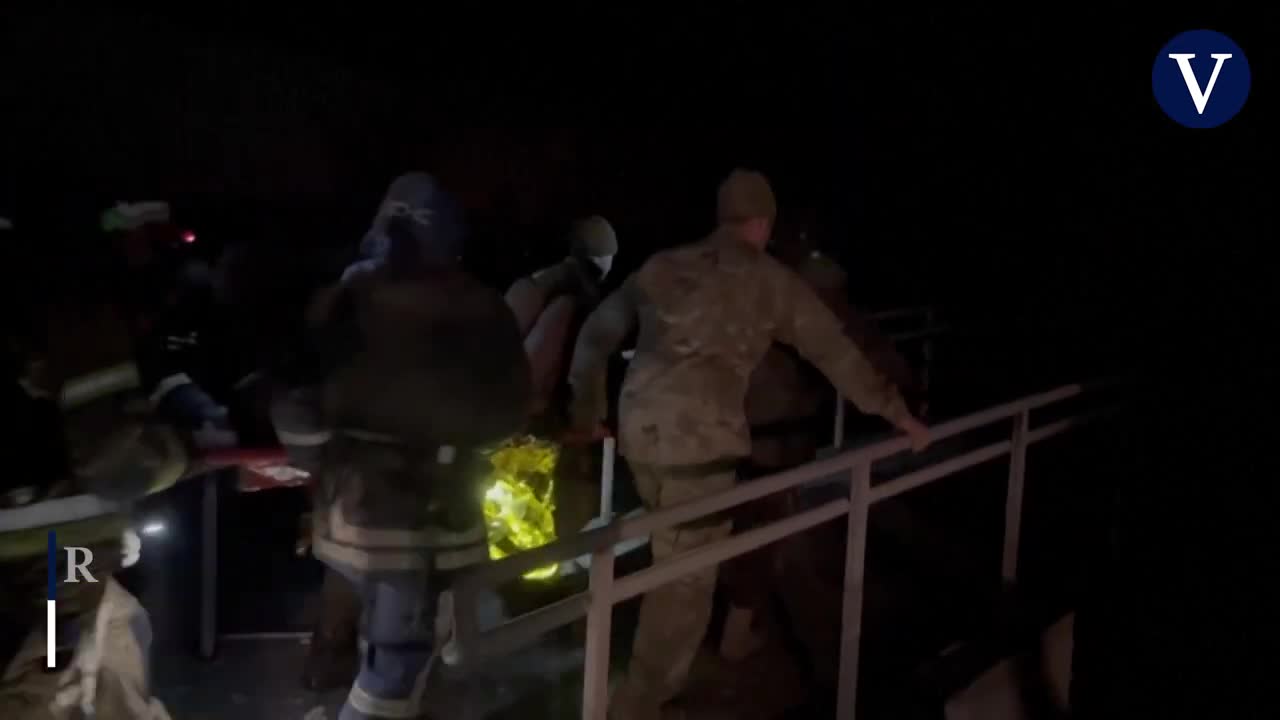 Emergency services rescue a man from the rubble of a bombed hospital