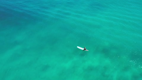 man on a surfboard waiting for wave