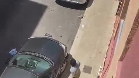 A man moved a dustbin on the road before a car hit it