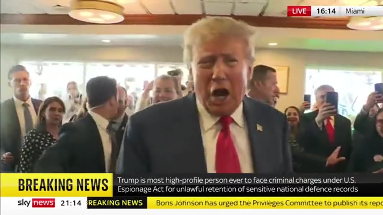 Trump leaves Miami court and is welcomed by fans who sing him 'Happy Birthday' at a local cafe.