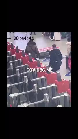 FEMALE WAITING FOR A PLANE AT THE AIRPORT SUDDENLY COLLAPSES AND SLIDES ALONG THE GROUND ON HER FACE
