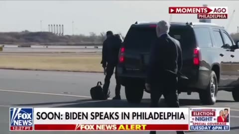 Biden walks past his car on the airport runway and walks off, appearing confused.