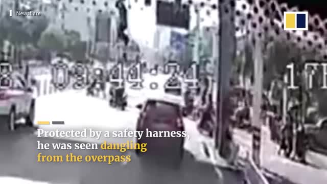 Bus catches worker dangling from bridge in China