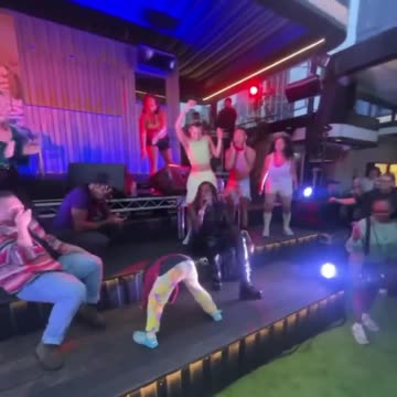Child twerks in front of audience at Melbourne's Rooftop Bar.