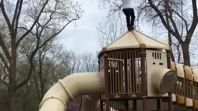 A man performs a reverse flip at an amusement park