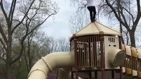 A man performs a reverse flip at an amusement park