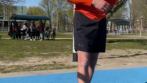 Athletic guy doing backflip in the park