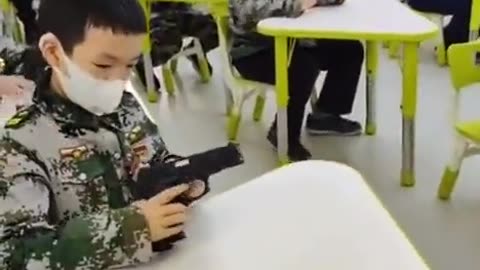 Chinese children learning to strip guns down (in school?)